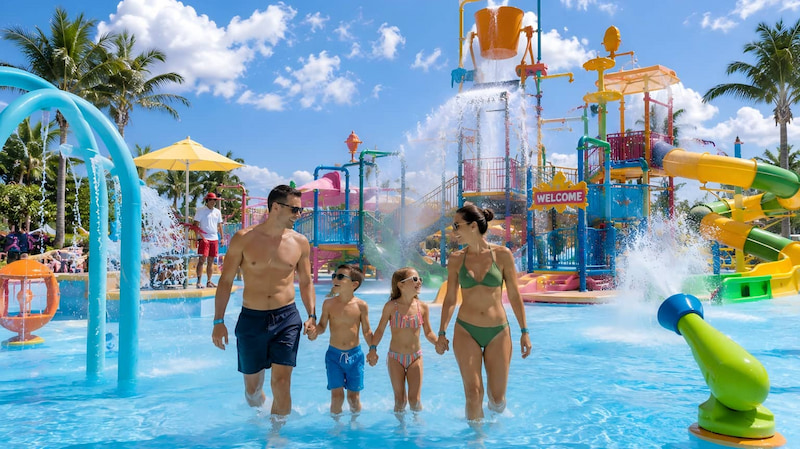 Family wearing waterproof RFID silicone wristbands at a colorful water park for access control and cashless payment